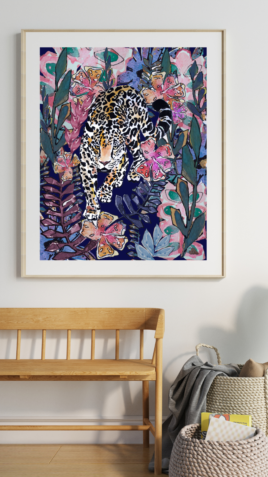 Framed artwork of a leopard among flowers on a wall above a wooden bench.